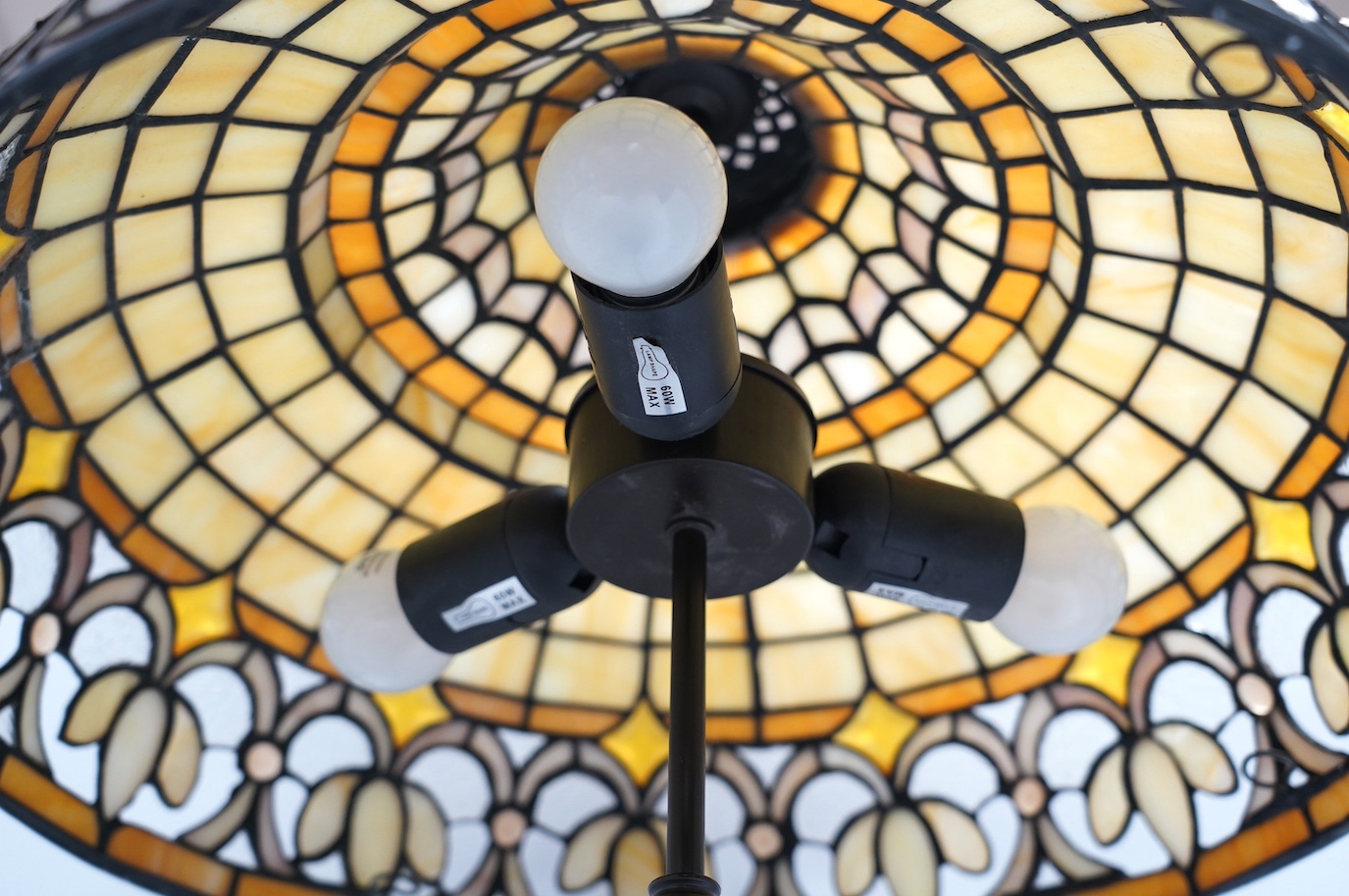 A Tiffany style coloured glass ceiling shade with pendant chains, 63cm high overall. Condition - fair to good.
